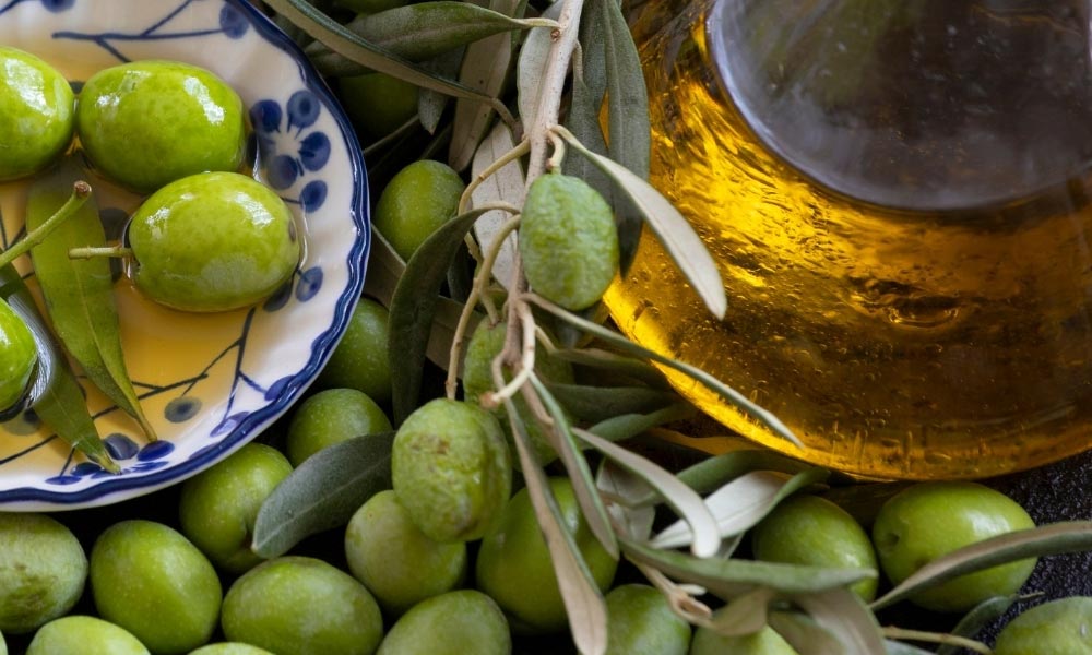 Zeytinler ve cam şişe içinde zeytinyağı